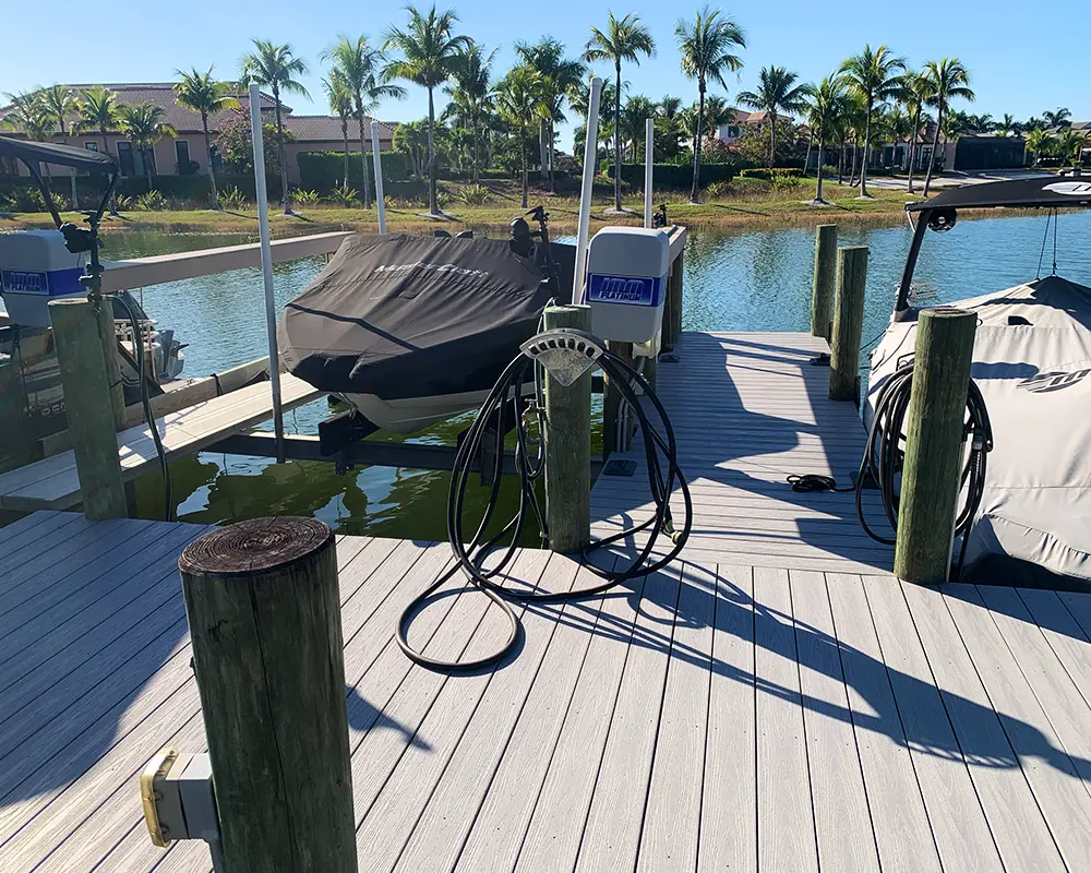 Boat Lift Options: Enhancing Your Waterfront Experience. Featuring a custom-built dock with multiple boat lifts on a canal in Southwest Florida.