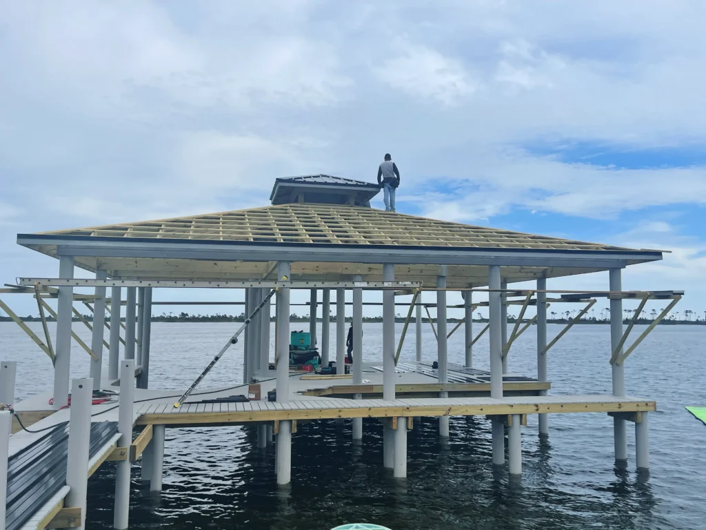 A dock with a pavilion roof under construction by Overall Outdoor & Marine Services.